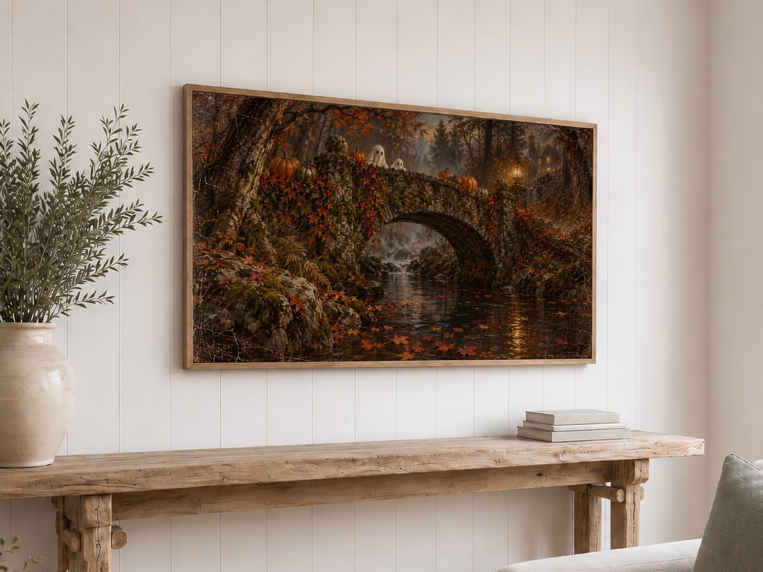 Autumn Ghosts on the Stone Bridge Frame TV art displayed on a white shiplap wall above a reclaimed-wood console table styled with olive branches in a cream ceramic vase and stacked books.