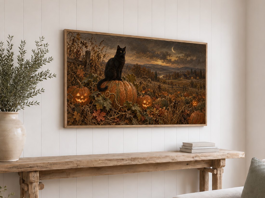 Halloween Frame TV Art displayed on a white shiplap wall above a reclaimed-wood console table with olive branches in a cream ceramic vase and books, showing a black cat perched on a jack-o'-lantern in an autumn pumpkin field.