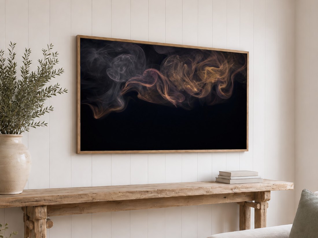 Abstract smoke tendrils in grey and gold on a light oak framed TV above a reclaimed-wood console with olive branches and neutral books, against a white shiplap wall for a calm, atmospheric focal point.