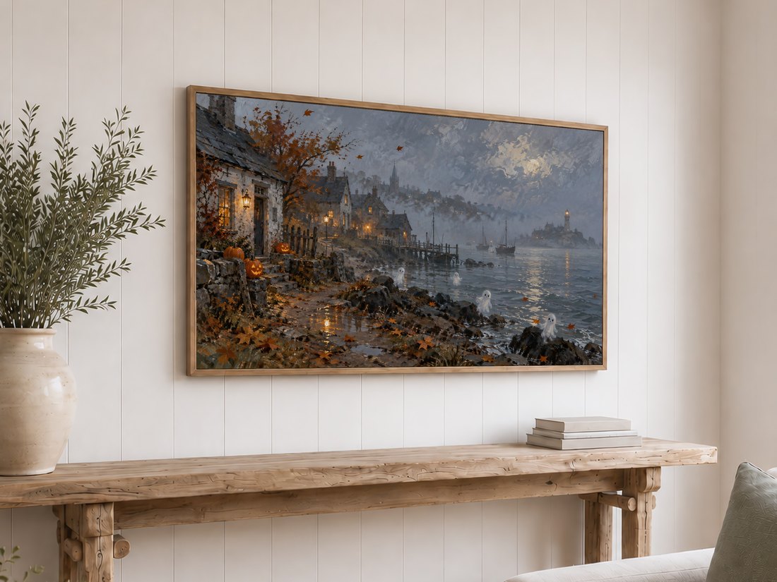 Haunting harbor landscape with jack-o'-lanterns and misty architecture displayed on a Frame TV above a rustic reclaimed-wood console table against white shiplap wall, with olive branches in cream ceramic vase and stack of neutral books.