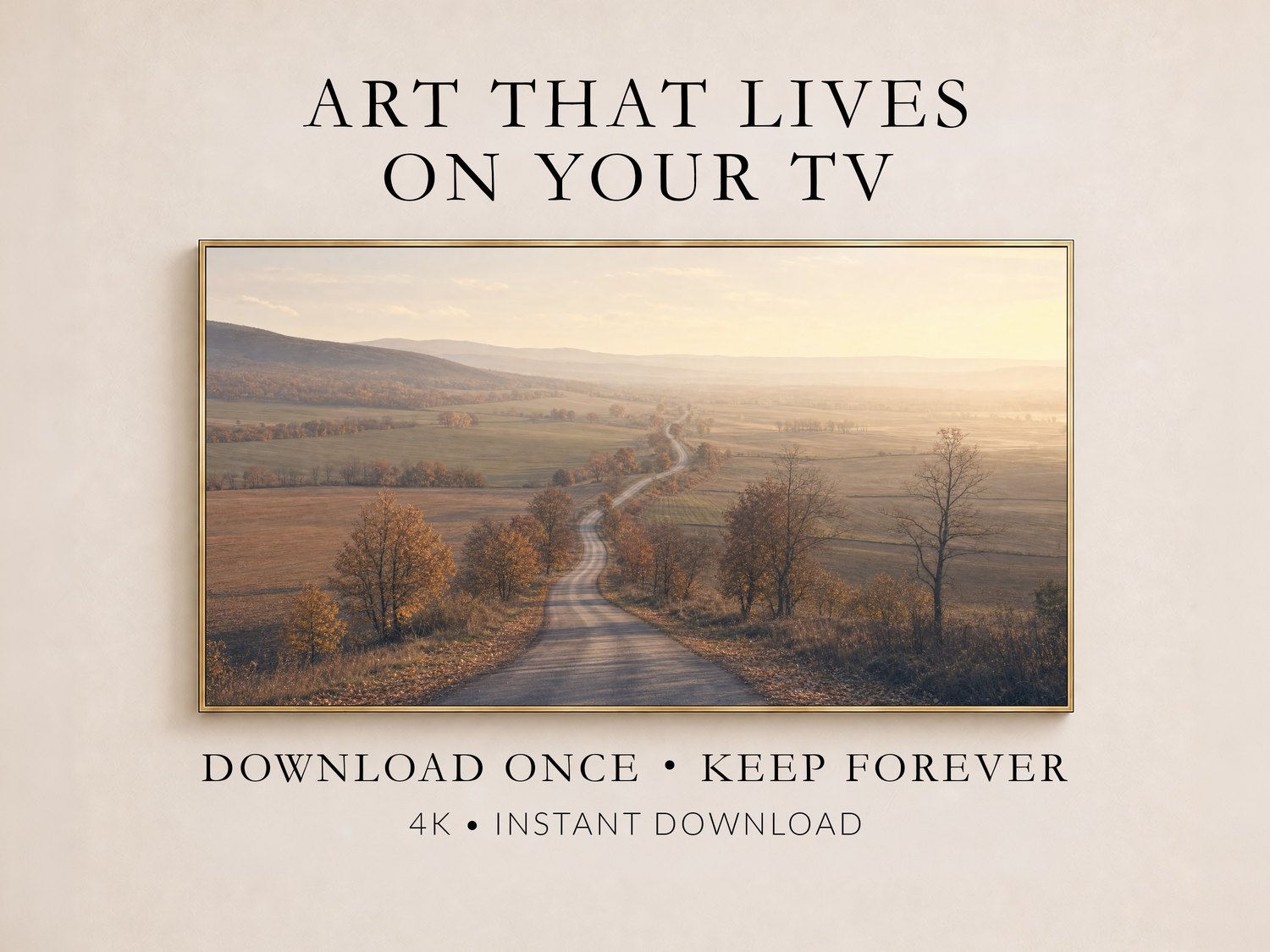 Autumn country road frame TV art displayed in a thin gold frame on a soft cream wall, showing a winding road through muted gold and rust farmland, promoting instant 4K digital download for your Frame TV.