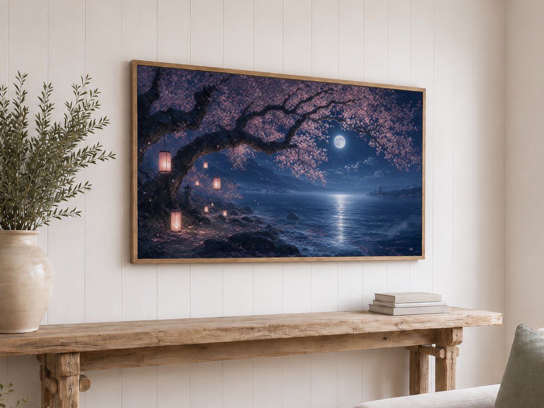 Sakura tree and moonlit water artwork on a light oak framed TV above a reclaimed-wood console with olive branches and neutral books, giving a shiplap living room a serene Japanese-inspired accent.
