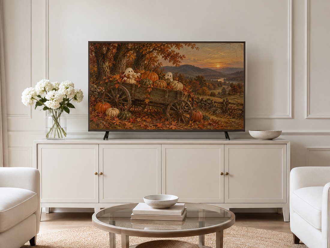 Autumn harvest Frame TV art displayed in a thin gold frame on a neutral living room cream wall above a cream sideboard, styled with white hydrangeas and pale armchairs.