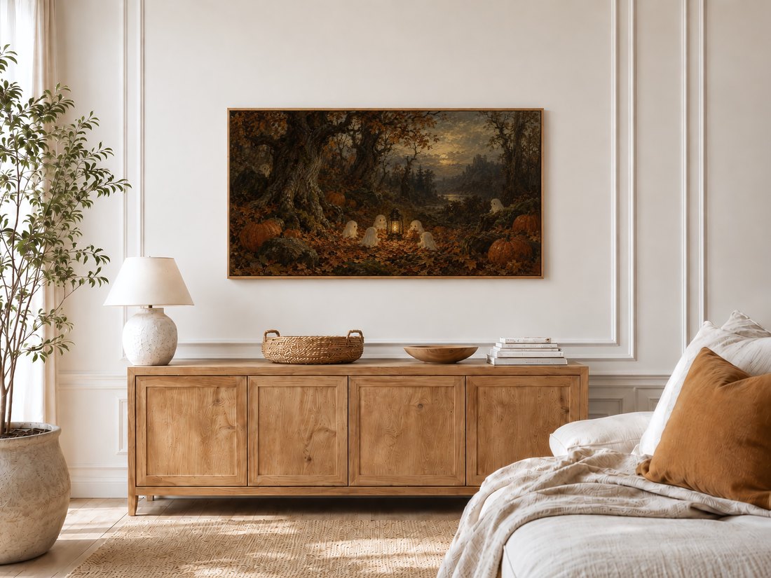 Enchanted forest Halloween art displayed in a bright bedroom with cream moulding above a light oak sideboard with ceramic lamp and olive tree by the window.
