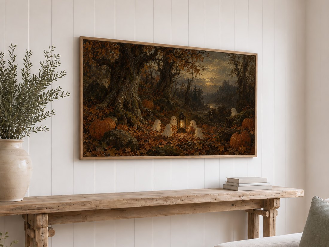 Haunted woodland frame TV art shown on white shiplap above a reclaimed-wood console table with cream ceramic vase and books in a cozy autumn-ready room.