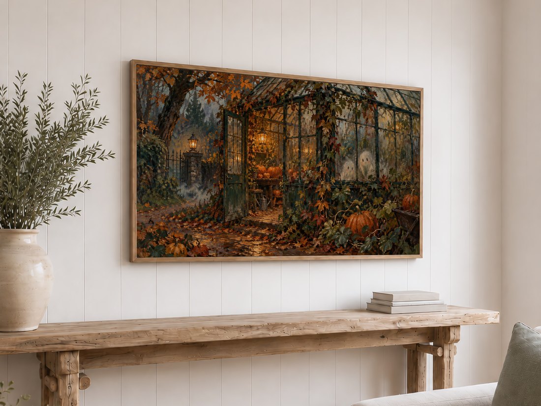 Autumn Pumpkin Greenhouse Frame TV Art displayed above a rustic reclaimed-wood console table on a white shiplap wall, with olive branches in a cream ceramic vase and stacked neutral books, showing the haunting fall greenhouse scene.