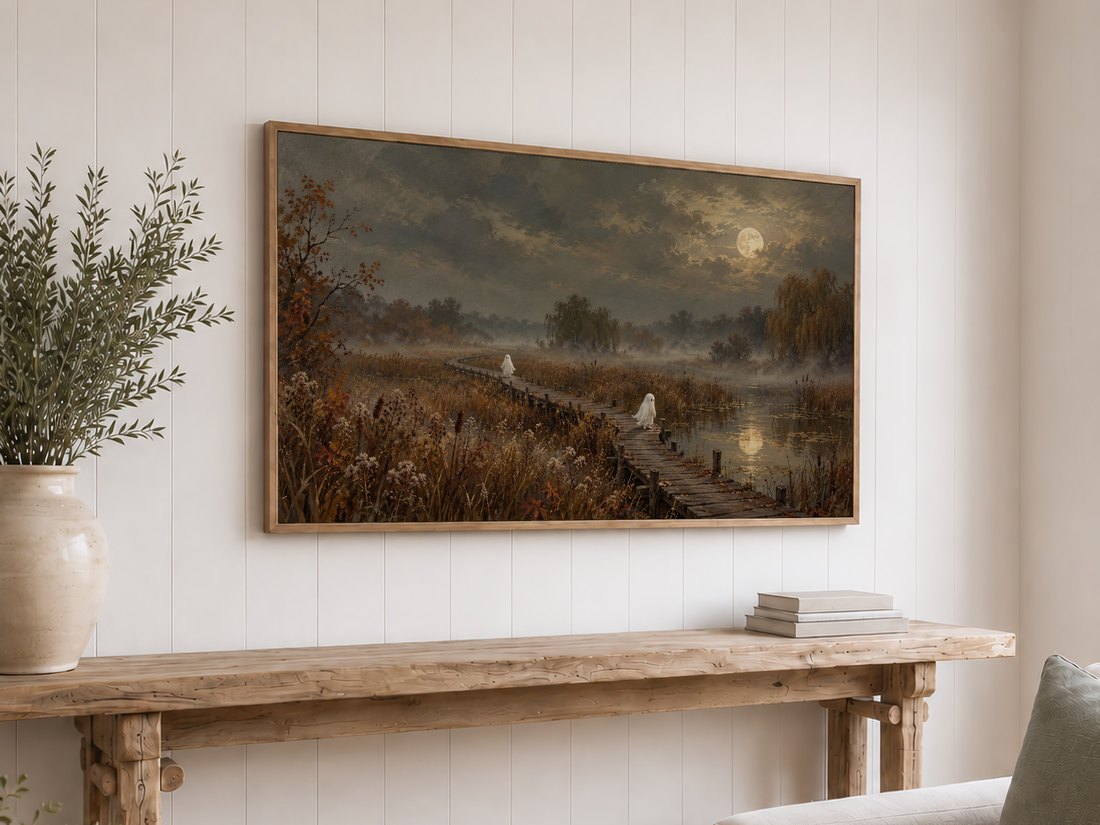 Ghostly figures walking across a misty autumn landscape displayed on a Frame TV in a light oak frame above a rustic reclaimed-wood console table with olive branches and neutral books