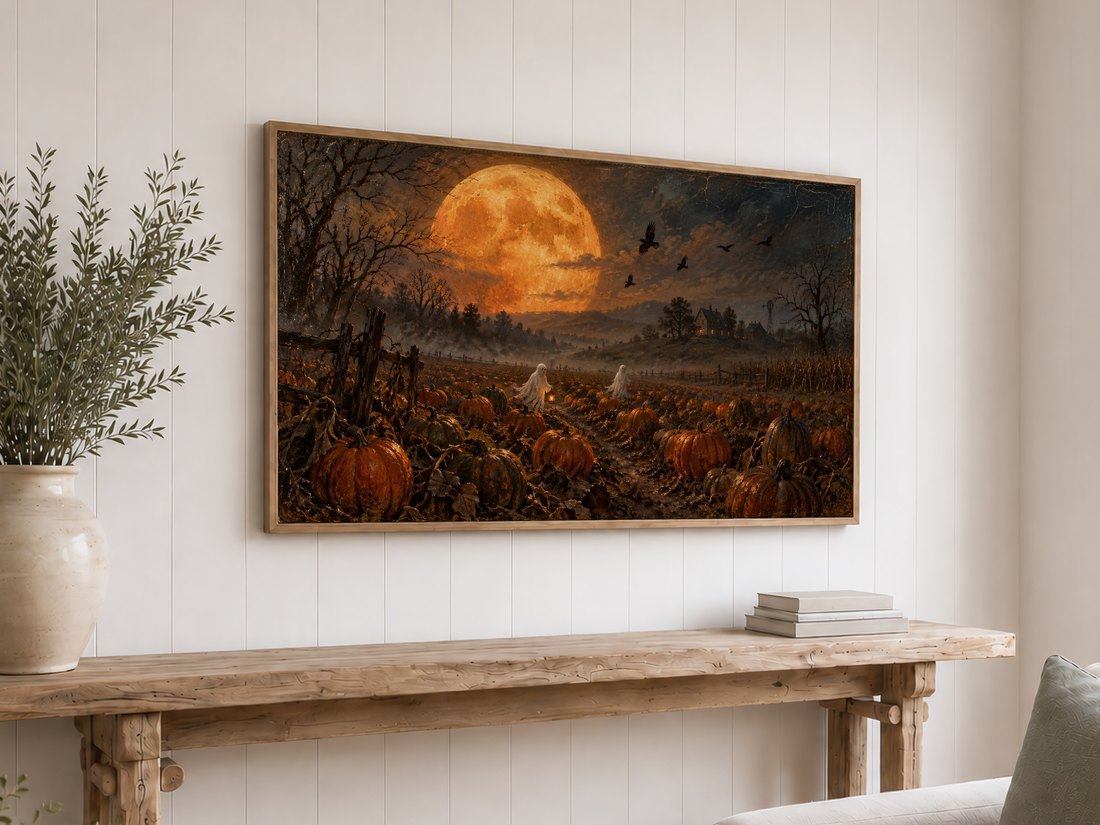 Harvest Moon Over the Pumpkin Field shown on Frame TV above reclaimed-wood console table on white shiplap wall, with olive branches and books below.