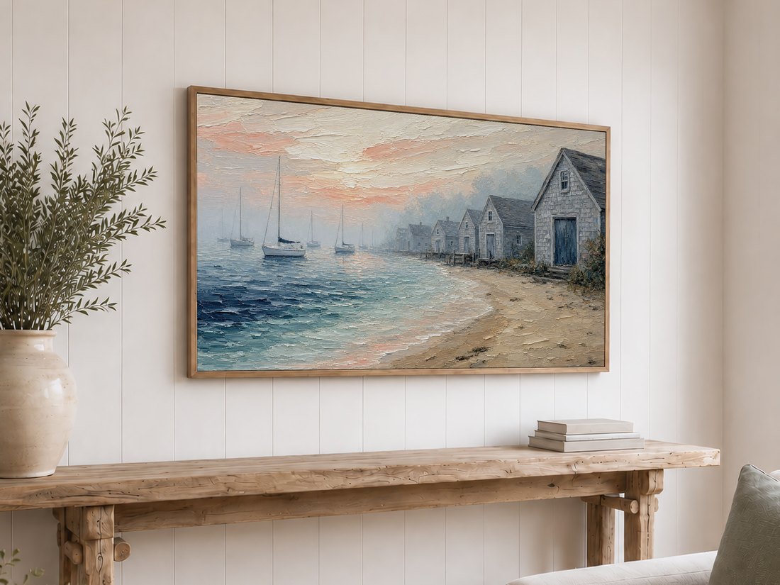Coastal harbor painting displayed on a light oak framed TV above a reclaimed-wood console with olive branches, set against a white shiplap wall for an easy coastal farmhouse look.