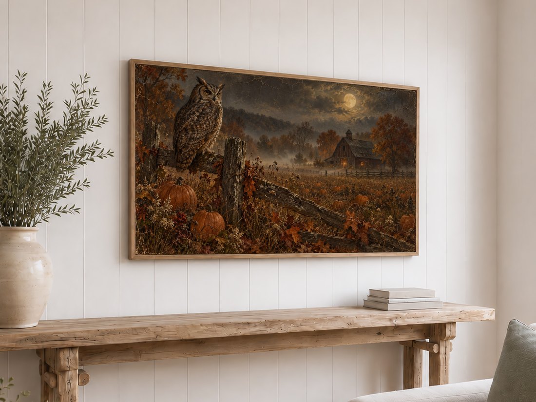 Autumn pumpkin field and moonlit owl artwork displayed on a Frame TV above a rustic reclaimed-wood console table on white shiplap, styled with cream ceramic vase and olive branches.