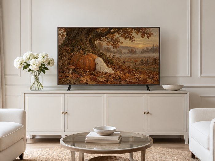 Sleepy Ghost Beneath the Oak Tree artwork shown on a Frame TV in a neutral living room with cream panelled walls, a cream sideboard, white hydrangeas in a glass vase, round glass table and pale armchairs.