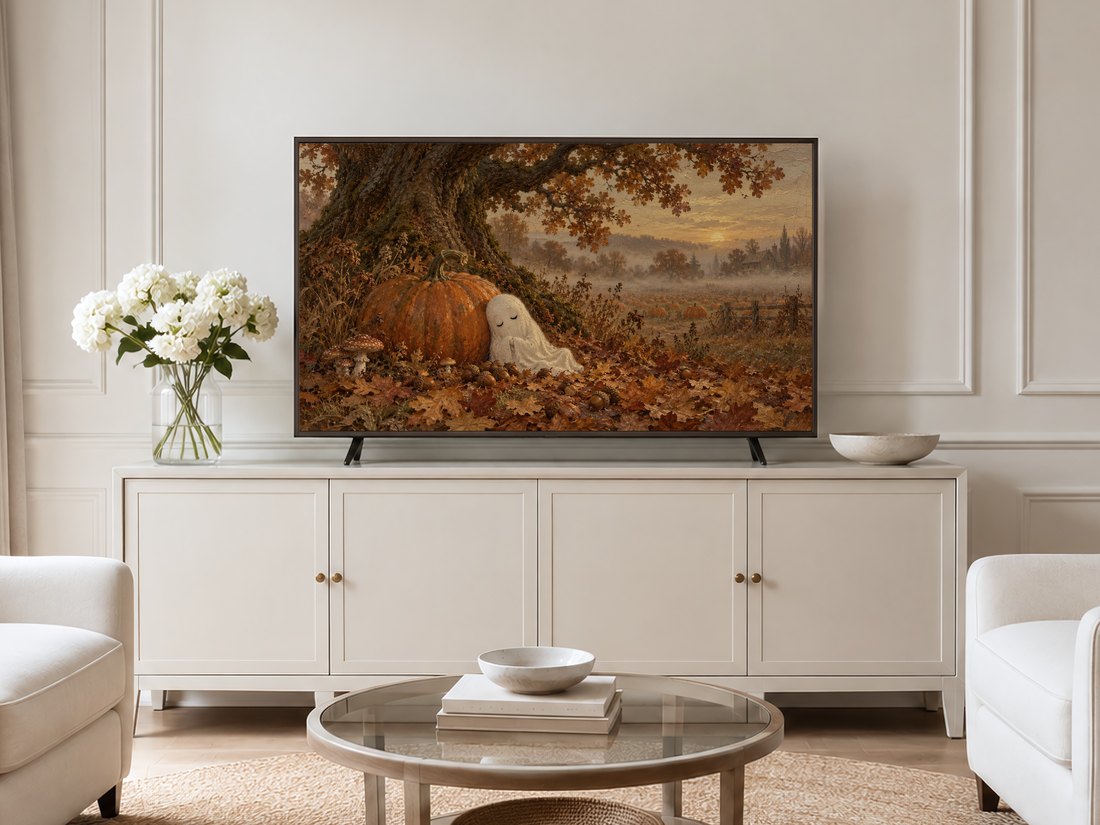 Sleepy Ghost Beneath the Oak Tree artwork shown on a Frame TV in a neutral living room with cream panelled walls, a cream sideboard, white hydrangeas in a glass vase, round glass table and pale armchairs.
