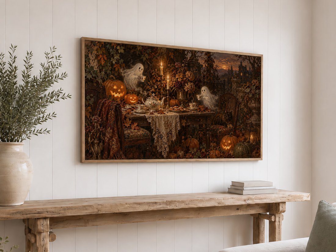 Ghostly autumn tea party Frame TV art shown in light oak frame above reclaimed-wood console table on white shiplap wall, with cream ceramic vase and olive branches.