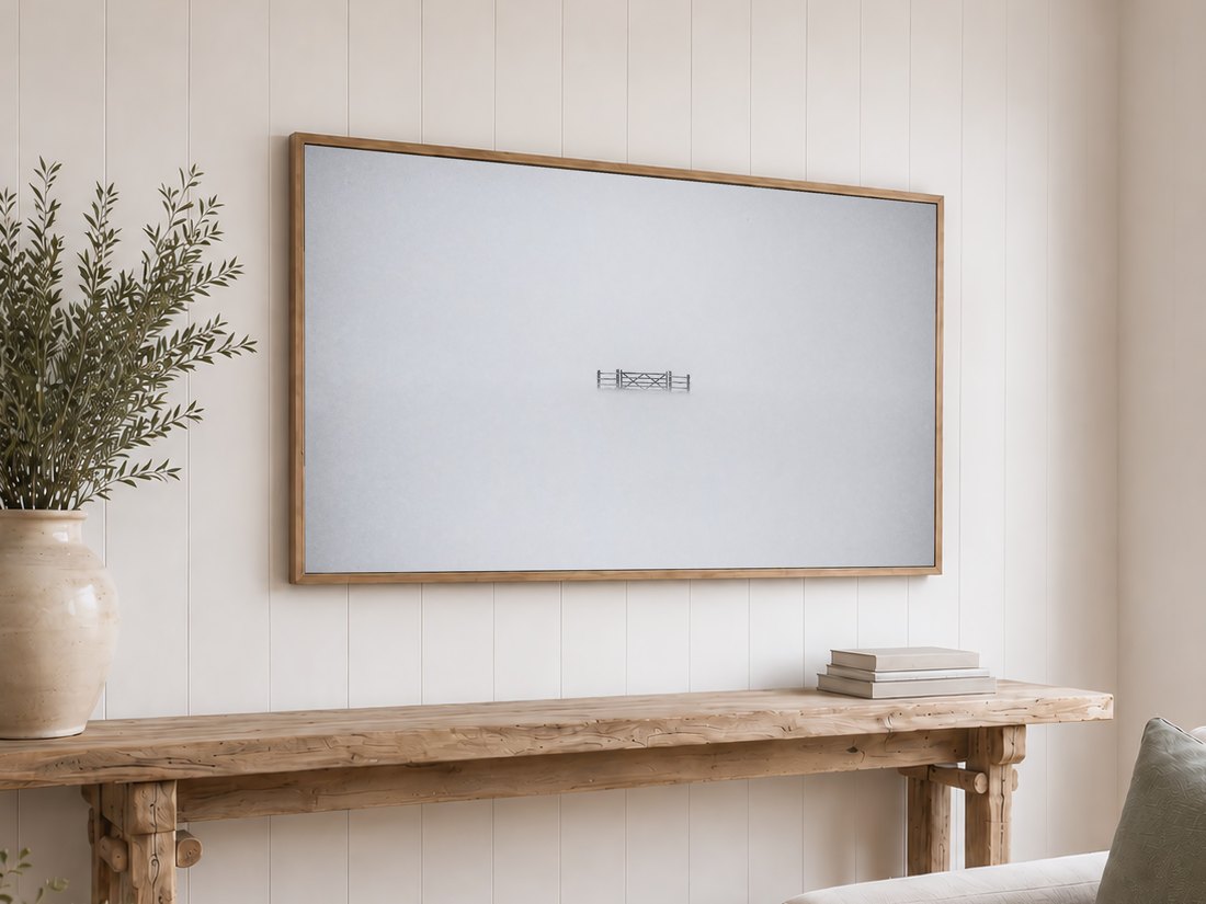 Solitary gate in mist featured on a Frame TV mounted above a reclaimed-wood console table on white shiplap, styled with olive branches and neutral books.